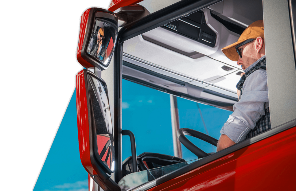 Male commercial truck driving student looking into side mirror