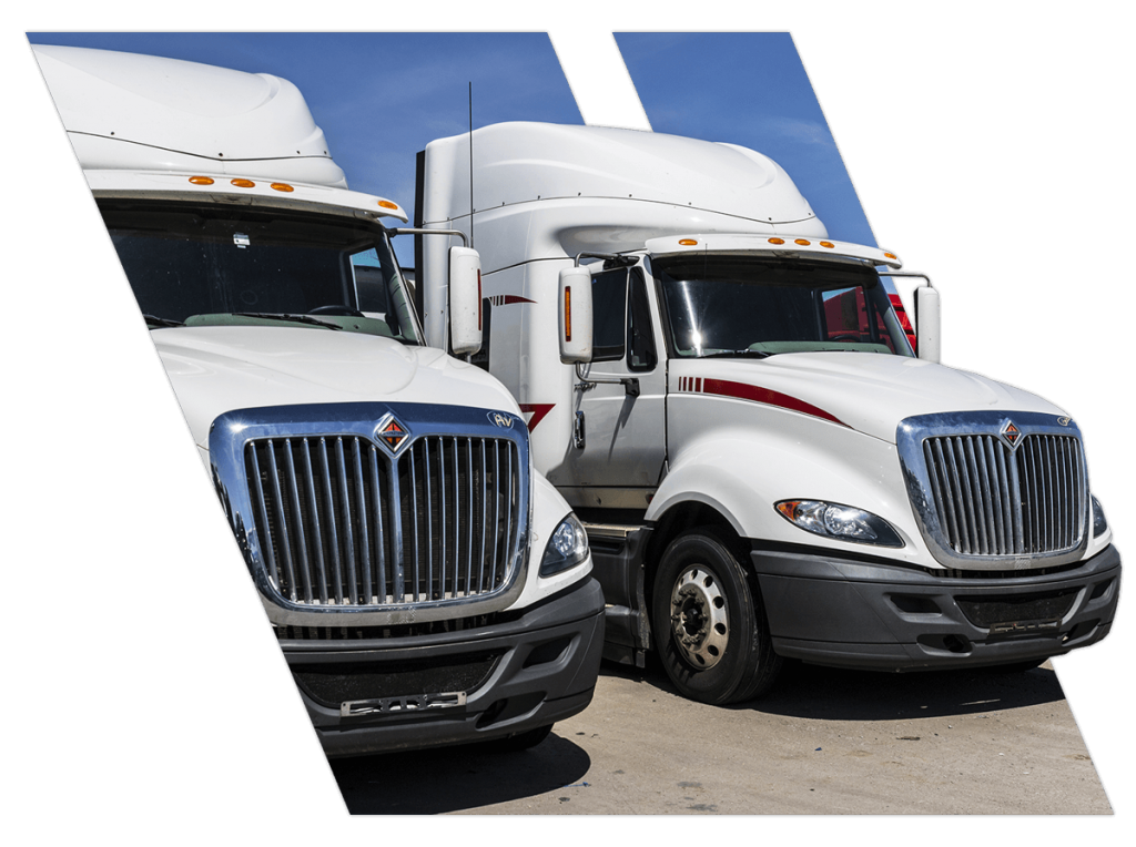 Two big trucks lined up in a Hammond parking lot