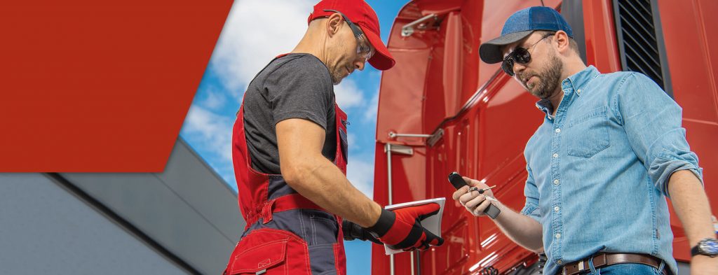 Two male truckers discussing types of CDL restrictions