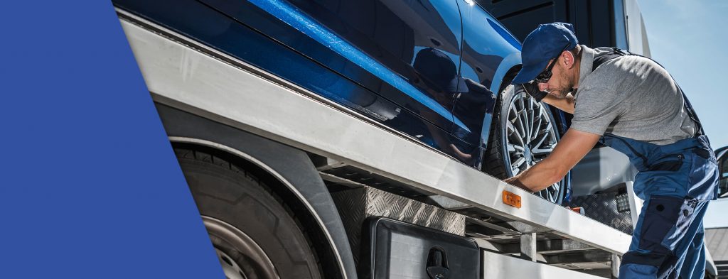 A truck driver, hired during the 2023 shortage, working on his new truck.