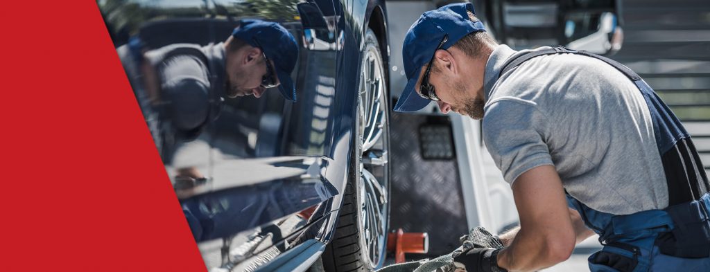 A truck driver working on his truck as part of his new truckers guide tips