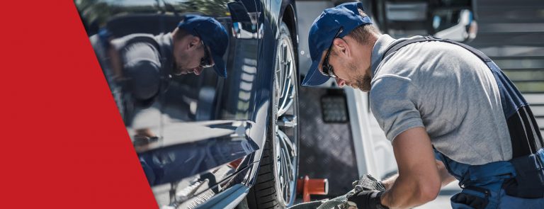 A truck driver working on his truck as part of his new truckers guide tips