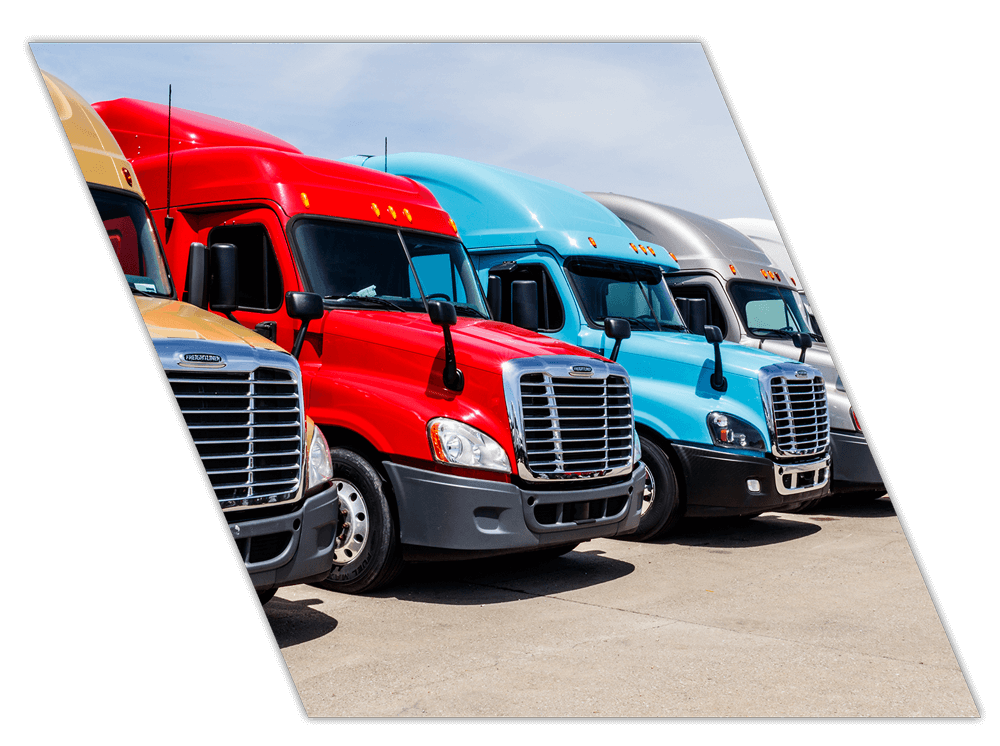 Multi colored trucks parked in lot for training for company drivers in Texas